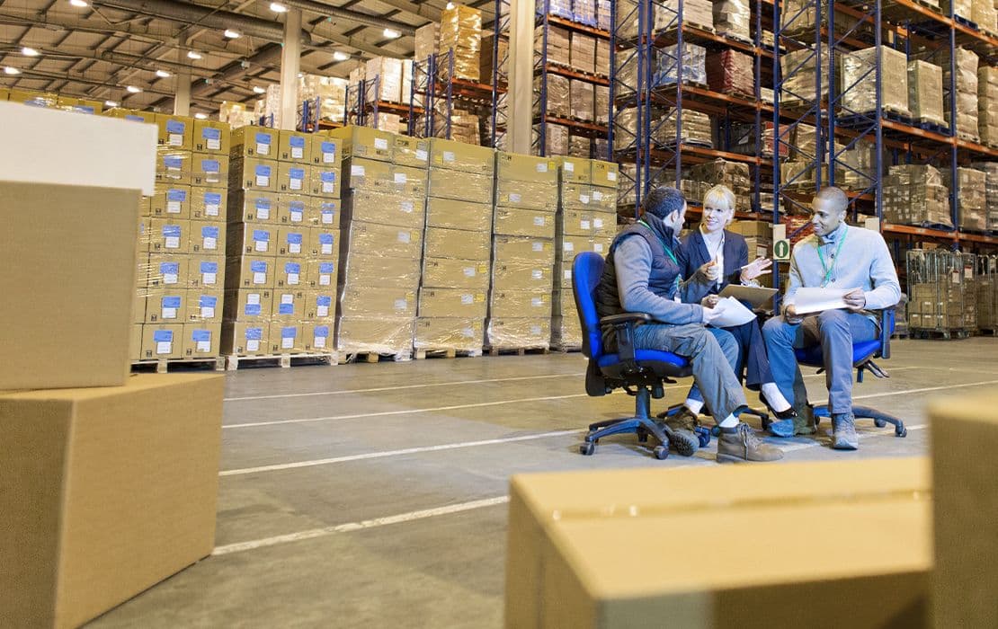Mitarbeiter arbeiten auf ergonomischen Bürostühlen im Lagerbüro für gesundes Arbeiten am Arbeitsplatz